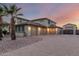 Spacious home featuring a three-car garage, desert landscaping, and a private gate at 14494 W Yucatan St, Surprise, AZ 85379