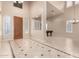 Open concept foyer with high ceiling and hardwood front door leading to open area with billiards table at 14494 W Yucatan St, Surprise, AZ 85379
