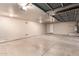 Large, empty three car garage with door openers installed at 14494 W Yucatan St, Surprise, AZ 85379