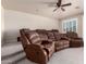 Home theater with tiered seating, plush reclining chairs, and ceiling fan at 14494 W Yucatan St, Surprise, AZ 85379