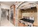Kitchen features stainless appliances, granite counters, stone accents, and range hood at 14494 W Yucatan St, Surprise, AZ 85379