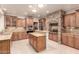 Gourmet kitchen boasts granite counters, stainless appliances, tile flooring, and stone accent wall at 14494 W Yucatan St, Surprise, AZ 85379