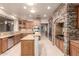 Open kitchen features granite counters, tile floors, stone archway over the stove, and stainless steel appliances at 14494 W Yucatan St, Surprise, AZ 85379