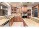This kitchen offers granite counters, stainless appliances, tile floors, and wood cabinets at 14494 W Yucatan St, Surprise, AZ 85379