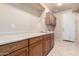 This spacious laundry room includes ample cabinets and long countertop at 14494 W Yucatan St, Surprise, AZ 85379