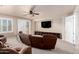 Inviting living room featuring a ceiling fan, plush carpet and comfortable seating for relaxation at 14494 W Yucatan St, Surprise, AZ 85379
