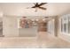 Living room showcasing tile flooring and view into kitchen with light brown cabinetry and a brick backsplash at 14494 W Yucatan St, Surprise, AZ 85379