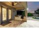 Covered patio with built-in grill and pond at 14494 W Yucatan St, Surprise, AZ 85379
