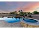 An in-ground pool and hot tub with lush landscaping at 14494 W Yucatan St, Surprise, AZ 85379