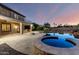 Resort-style backyard with pool, spa, covered patio, and outdoor kitchen, perfect for entertaining at 14494 W Yucatan St, Surprise, AZ 85379