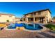 Expansive pool with rock features and well-maintained landscaping, ideal for outdoor enjoyment at 14494 W Yucatan St, Surprise, AZ 85379