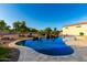 Stunning backyard pool with stone accents and travertine deck, perfect for relaxation and entertainment at 14494 W Yucatan St, Surprise, AZ 85379