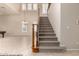 Elegant staircase featuring carpeted steps and a wooden handrail, leading to the upper level at 14494 W Yucatan St, Surprise, AZ 85379