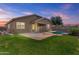 Well-manicured backyard featuring a fenced pool and green grass, perfect for outdoor enjoyment at 14676 W Banff Ln, Surprise, AZ 85379