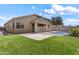 Backyard features a grass lawn, a fenced swimming pool, and a covered patio area at 14676 W Banff Ln, Surprise, AZ 85379