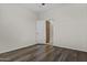 Spacious bedroom with hardwood flooring and a walk-in closet with wooden shelving at 14676 W Banff Ln, Surprise, AZ 85379