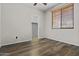Bedroom with walk-in closet, hardwood floors, and window with blinds at 14676 W Banff Ln, Surprise, AZ 85379