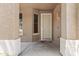 A welcoming front porch with neutral tones and a decorative door, creating a pleasant entry at 14676 W Banff Ln, Surprise, AZ 85379