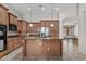 Well-equipped kitchen featuring granite countertops and custom wood cabinetry at 14676 W Banff Ln, Surprise, AZ 85379