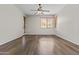 Bright, vacant living room featuring hardwood floors and window with blinds at 14676 W Banff Ln, Surprise, AZ 85379