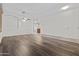 Open living area featuring hardwood floors and a seamless flow to the rest of the home at 14676 W Banff Ln, Surprise, AZ 85379