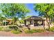 Community pavilion, with stone columns, a concrete patio, and nearby playground at 14676 W Banff Ln, Surprise, AZ 85379