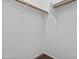 A walk-in closet features wood trim shelves and a hanging rod at 14676 W Banff Ln, Surprise, AZ 85379