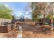 Enjoy the backyard with trampoline, seating and dining furniture, all shaded by mature trees at 1507 W Mesquite Ave, Apache Junction, AZ 85120