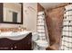 Bathroom featuring neutral walls, tile shower, and dark wood vanity at 1507 W Mesquite Ave, Apache Junction, AZ 85120