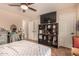 Bedroom featuring ceiling fan, closet, TV, and wood-look tile flooring at 1507 W Mesquite Ave, Apache Junction, AZ 85120