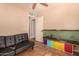 Bedroom featuring couch, fish tank, and wood-look tile flooring at 1507 W Mesquite Ave, Apache Junction, AZ 85120