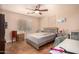 Bedroom with ceiling fan, neutral walls, and wood-look tile flooring at 1507 W Mesquite Ave, Apache Junction, AZ 85120