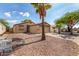 Well-kept single-story home boasting desert landscaping, lengthy driveway, and a secure front entryway at 1507 W Mesquite Ave, Apache Junction, AZ 85120