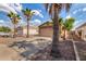 Inviting home featuring a lengthy driveway, desert landscaping, and an attached two-car garage at 1507 W Mesquite Ave, Apache Junction, AZ 85120