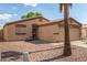 Cozy home featuring desert landscaping, a secure front entrance, and an attached two-car garage at 1507 W Mesquite Ave, Apache Junction, AZ 85120