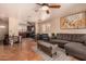 Open concept living room and kitchen with tile floors, ceiling fans, and modern decor at 1507 W Mesquite Ave, Apache Junction, AZ 85120