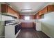 Functional kitchen featuring a gas range, overhead cabinets, and ample counter space for meal preparation at 1614 S 6Th Ave, Phoenix, AZ 85003