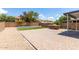 Expansive backyard with a built-in grill, brick patio, and manicured lawn, perfect for outdoor activities at 1632 E Leslie Ave, San Tan Valley, AZ 85140