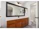 Bathroom featuring a dark vanity, black framed mirror, and framed vanity mirror at 1632 E Leslie Ave, San Tan Valley, AZ 85140