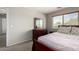 Bedroom with a window, a wood-framed bed, and a dresser with a mirror at 1632 E Leslie Ave, San Tan Valley, AZ 85140