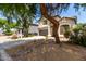 Charming two-story home with a well-manicured front yard, a two car garage and mature trees at 1632 E Leslie Ave, San Tan Valley, AZ 85140