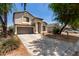 Charming two-story home with a well-manicured front yard, a two car garage and mature trees at 1632 E Leslie Ave, San Tan Valley, AZ 85140