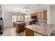 Bright eat-in kitchen with oak cabinets, tiled countertops, and a center island at 1632 E Leslie Ave, San Tan Valley, AZ 85140