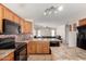 Spacious kitchen with tiled backsplash, a black appliance package, and an island at 1632 E Leslie Ave, San Tan Valley, AZ 85140