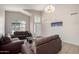 Inviting living room featuring high ceilings, large windows, neutral paint and tile flooring at 1632 E Leslie Ave, San Tan Valley, AZ 85140
