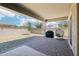 Expansive backyard featuring a covered patio, BBQ grill, and a relaxing egg chair at 1865 N 141St Ave, Goodyear, AZ 85395