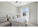 Comfortable bedroom featuring a large window with sheer curtains, a soft bed, and neutral decor at 1865 N 141St Ave, Goodyear, AZ 85395