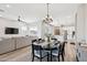 Open dining and living space with views of a modern kitchen; great for entertaining at 1865 N 141St Ave, Goodyear, AZ 85395