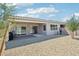Rear exterior showcasing a covered patio, desert landscaping, and contemporary design at 1865 N 141St Ave, Goodyear, AZ 85395