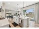 Contemporary kitchen featuring white countertops, stainless appliances, and an open layout to the dining and living areas at 1865 N 141St Ave, Goodyear, AZ 85395